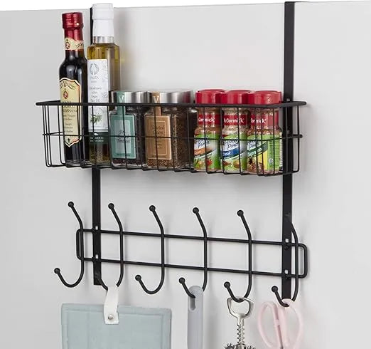 Wall-mounted spice rack with bottles and hooks on a white wall