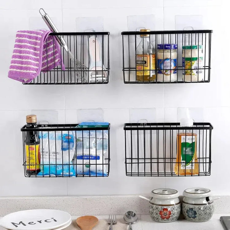 Wall-mounted black metal baskets with kitchen items on a tiled wall.