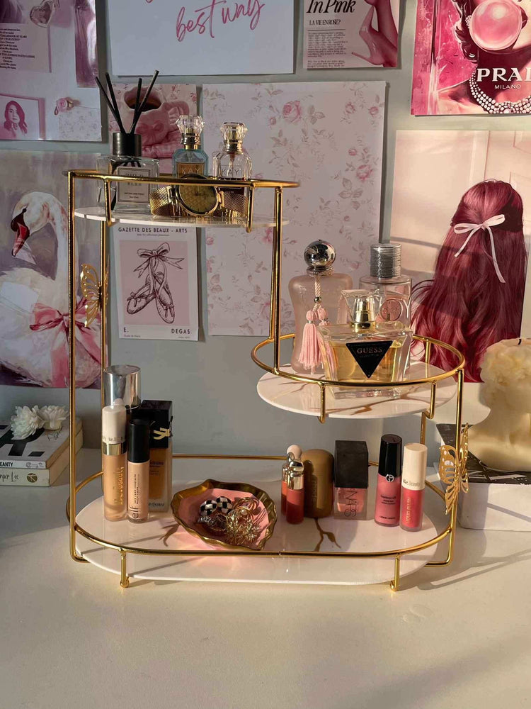 Makeup and perfume set on a decorative stand with a stylish background