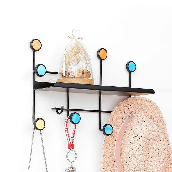 Front view of Nordic-style rectangular wall shelf with hooks mounted on a white wall