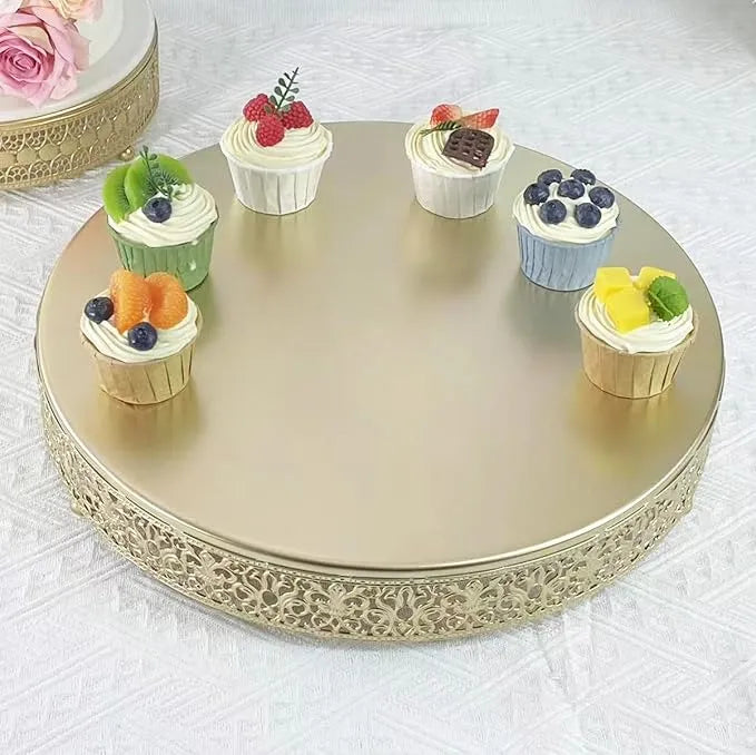 Decorative round gold tray with small cupcakes on a white surface