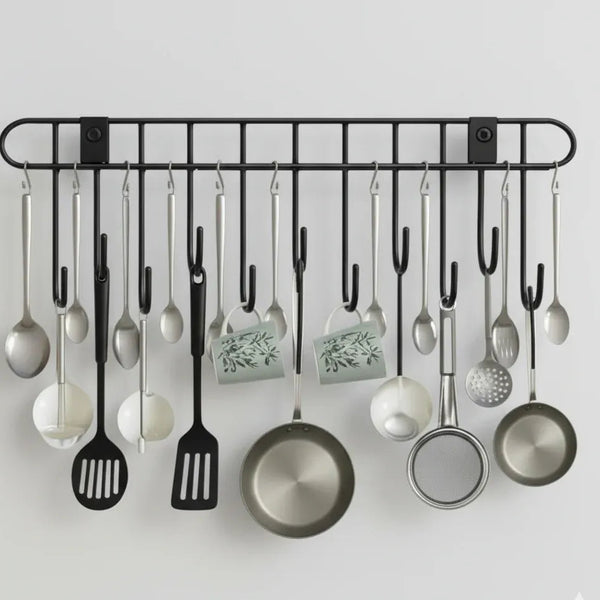 Wall-mounted kitchen utensil holder with various utensils on a light gray background